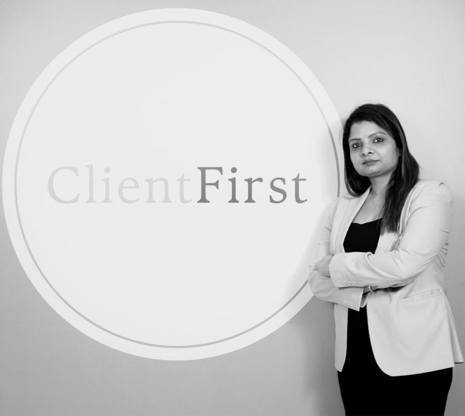 Simi Agarwal, founder of Sikka Wealthness, standing beside the ClientFirst wall at her Bhubaneswar office